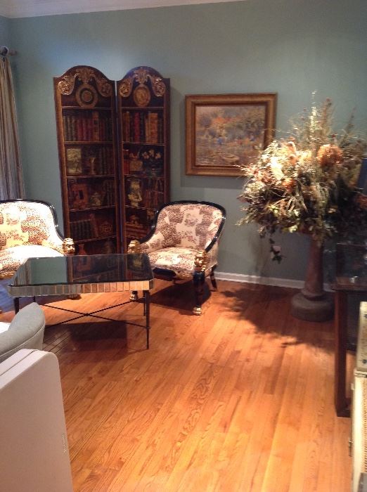 Faux book screen, pair of French Empire style chairs with lion heads, mirrored cocktail table
