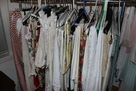 A RACK OF ASSORTED TABLE CLOTHS
