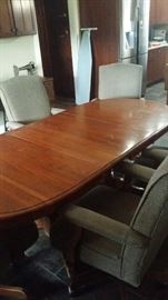 Nice solid table, 7 ft with 2 leafs, 5 ft without.  Six padded rolling chairs.