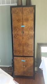 There are two of these very tall cabinets.  There is a matching piece that could connect them at the top for a large TV inbetween.  But it is not set up that way now.
