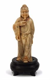 13. SHOUSHAN CARVED SCHOLAR壽山石 人物立像A contemplative scholar carved from Shoushan stone in a robe accented with blue and red stones. H:7in (ON STAND)
W: 2 1/2in  326g
