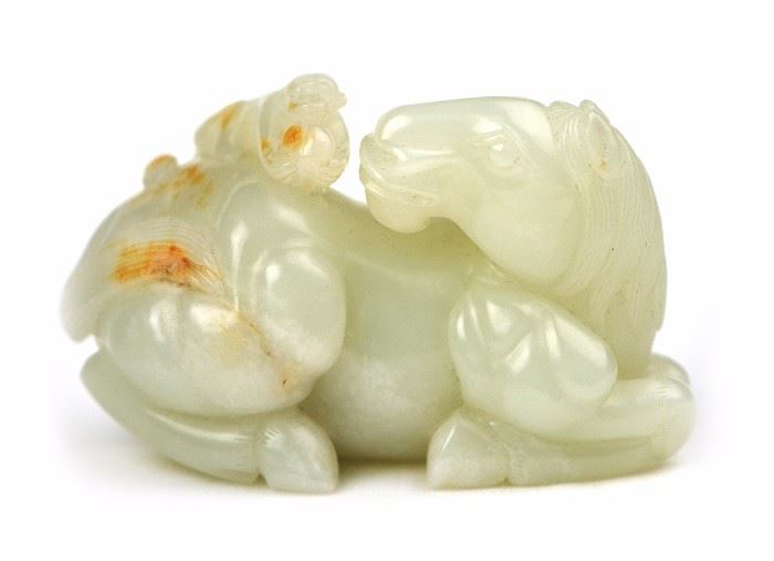 19. JADE CARVED HORSE AND MONKEY馬上封侯和田玉雕擺件Depicting a horse on it's haunches facing behind to a monkey holding a peach on its back. A monkey and horse together are an omen of good things to come in your career. 229g H: 2in W: 3 1/4in
