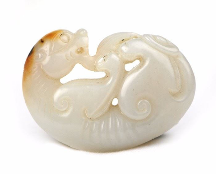 28. JADE MYTHICAL CREATURE白玉螭龙祥雲把件With a dark amber colored inclusion and a pale body, this jade has been carved into a mythical creature curled in on itself. 71g  H:2 1/4in W:1 1/2in
