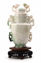50. JADE TAOTIE RINGED VASE 翡翠雕雙龍耳銜蓋瓶From an even milky white to dark green inclusions, this jade bottle features taotie masks on the face with banana leaf motifs, and chi dragon handles.  
22oz  H:8 1/2in W:4 1/4in
