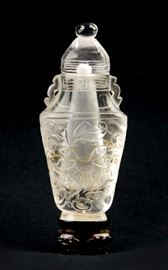 60. CRYSTAL SNUFF BOTTLE ON STAND水晶刻花鼻煙壺Slender in shape, this snuff bottle has been incised with floral patterns and a leiwan band around the neck. H:3in