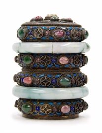 79. JEWELED JADE BANGLE TEA CANISTER掐絲琺瑯翡翠鐲百寶茶葉罐A cylindrical canister with an exterior decorated from repurposed jade and cloisonne bangles. H:4in W:3in
