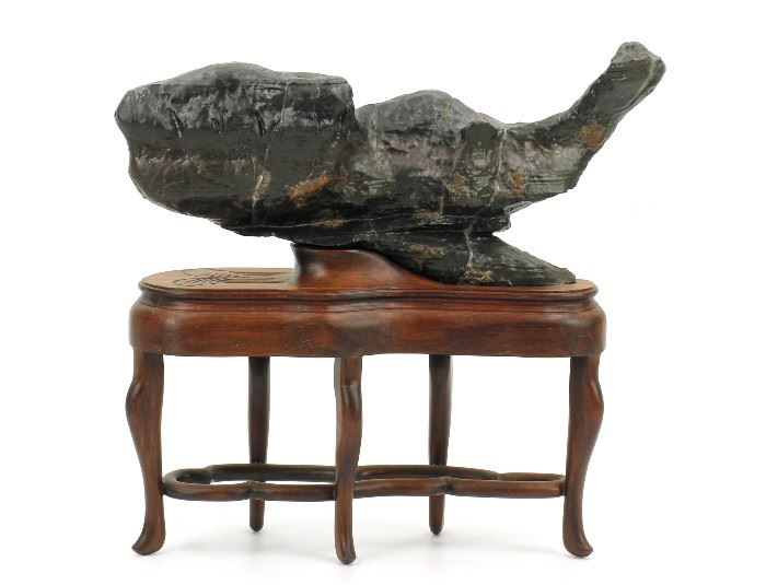 83. FISHI-SHAPED LINGBI STONE魚形靈壁石A Lingbi stone naturally shaped like a fish; with a nice wood stand; H: 9 in