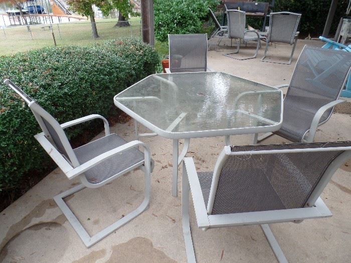 Outside Patio Set with Table and four(4) chairs. Table has opening for umbrella.