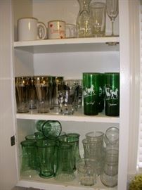 Assorted glassware.  Emerald green tall tumblers are vintage