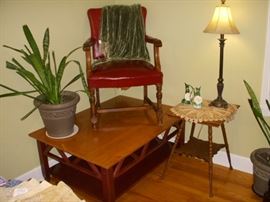 Ethan Allen coffee table displaying vintage chair (as found), & one of two potted plants.  Oak antique lamp table, etc.
