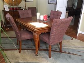 Stunning dining room table. Has ends that pull out, and 2 completely different sets of chairs. 6 each.