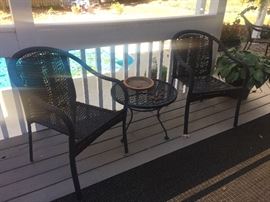 2 outdoor tables with a small table.