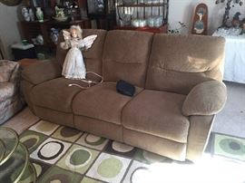 Couch with recliners and decorative angel