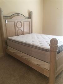 Massive queen bed has matching TV armoire.