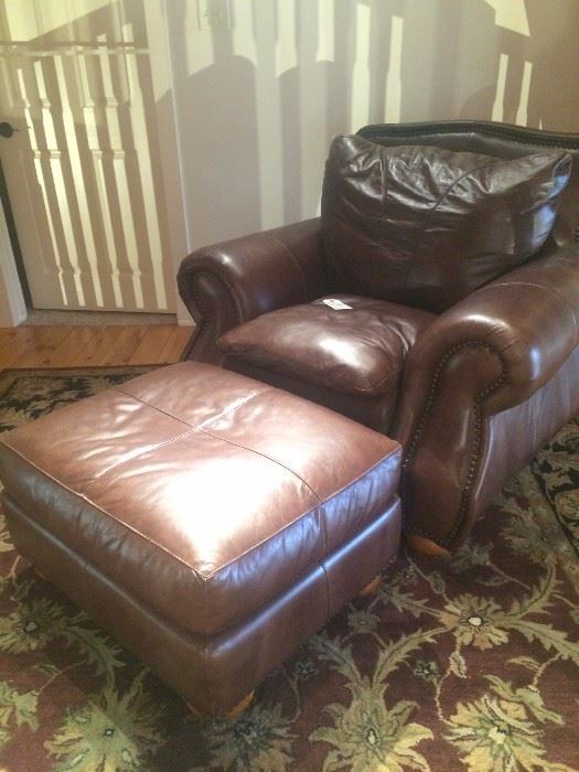 Brown leather club chair and ottaman (rug - not included in the sale)