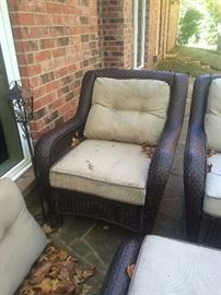 One of two matching patio chairs with matching ottoman