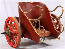 Lot#3, ROMAN STYLE CHARIOT FROM 1959, MGM MOVIE "BEN HUR" H 54", W 73", L 84"Movie prop from the film 'Ben Hur', released in 1959. Maroon in color with orange spoked wheel s with blades on the wheel hubs. Gilt tubular side hand rails. Tufted cushion on the floor board.