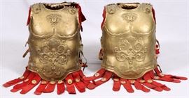 Lot#4, TWO PROP GOLD-PAINTED BREASTPLATES FROM "BEN HUR"Metro-Goldwin-Mayer, 1959. Gold-painted metal front and back breastplates, with brown leather straps and buckles, apron of red suede fringe with gold medallion decorations, attached muslin collar, and having a embossed decorated front. The interior of each marked with MGM inventory numbers.

Provenance: Accompanied by original receipt from David Weisz Co, MGM Auction and Tag Sale, 1970.