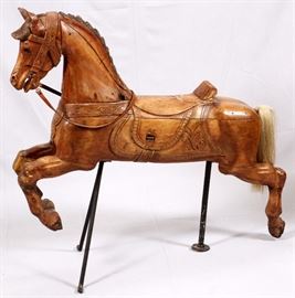 Lot#16, HAND CARVED PINE AMERICAN CAROUSEL HORSE, H 46", W 50"Put together with pegs, carved integral saddle and bridle, leather reins.