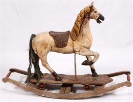 Lot#17, Put together with pegs, carved integral saddle and bridle, leather reins.Having a carved wood mane, leather saddle and horsehair tail. Can be removed from the rockers and has a platform with cast iron wheels for rolling on a flat surface.