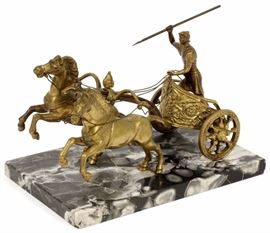 Lot#84, BRASS AND MARBLE SCULPTURE, H 6.5", L 11", ROMAN CHARIOTEER WITH TOW HORSES. Depicts a Roman charioteer holding a spear in one hand and reins in the other, and charging horses. On a black marble base L.11.5" x W.7.75"