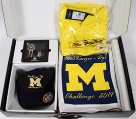 Lot#283, UNIVERSITY OF MICHIGAN ASSORTED CLOTHING, BLANKETS, HELMETS, ACCESSORIES, VINTAGE, 30 PIECES. Assorted garb and unique accessories including: belts, neckties, hats, scarves, shirts, retro jerseys, striped overalls, modern reproduction of early leather football helmets, windbreakers, raingear, blankets, etc. The Estate of Frederick C. and Malora Matthaei.