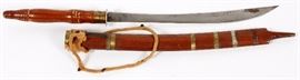Lot#338, KNIFE IN SHEAF, L 27"Malaysian? Having notch decorations on back edge of 18"  blade. Wood handle and sheath with brass bands.