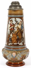Lot#1012, VILLEROY AND BOCH METTLACH POTTERY MAGNUM STEIN, C. 1910, H 20"German, circa 1910. Depicting a musical tavern scene. Having impressed castle mark and 1818 stamped to underside. Signed C. Gorgis.