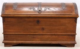 Lot#1065, CONTINENTAL DOME-TOP PINE CHEST, 19TH C., H 31", W 24", L 4'A continental dome-top pine chest. Possibly Flemish, 19th century. With hand-wrought iron strap work and hinges and iron carrying handles to sides. Having a rectangular shape, opening to a void interior, with molding details throughout. Raised on bracket feet.