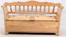 Lot#1066, CONTINENTAL BENCH WITH HINGED SEATS, H 34" L 68"Possibly Danish, early 20th century. Having a shaped and open back rail with curved side rails, the seat with two hinged doors opening to storage, raised on block feet.