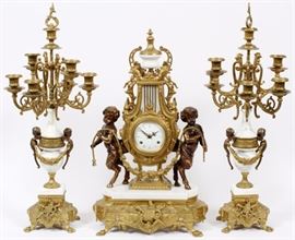 Lot#1082, GERMAN "IMPERIAL" BRONZE AND MARBLE CLOCK & PAIR OF CANDELABRAS. Made in Germany. Imperial clock H 24" flanked by bronze satyrs, clock case in shape of harp. Candelabras with eight arms and center snuffer. H 27". Circa 1960.