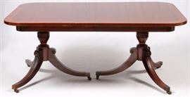 Lot#1098, BERKEY AND GAY MAHOGANY DINING TABLE, W 32" L 64" + 3 BOARDS. Circa 1940.  A two pedestal table, each with tripod curved fluted legs, on brass casters. Top has rounded corners and two fruit wood inlays parallel to the edge. H 28.5", L 64", D 32" with three leaves, each L 11".  Height 28.5".
