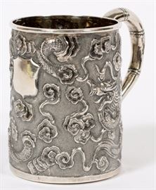 Lot#1327, WANG HING & CO. CHINESE EXPORT SILVER MUG H 3"A Chinese export silver mug manufactured by Wang Hing & Company. The tapering cylindrical exterior with dragons chasing flaming pearl motif, and with a bamboo stylized handle. Having impressed maker's mark to underside.