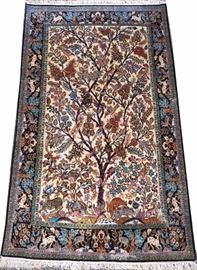 Lot#2065, PERSIAN QUM TREE OF LIFE PURE SILK CARPET, 1980, 5' 4" X 3' 4"  A center tree design decorated with animals in shades of brown, cream, red, orange, blues, black, green and beige.