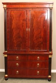 Lot#2259, BAKER MAHOGANY LINEN PRESS, H 79 1/2", L 50", D 20"  Ebonized and gilt columns flanking two upper paneled doors and three lower drawers. From the estate of D. J. Kennedy, Grosse Pointe, Mi.