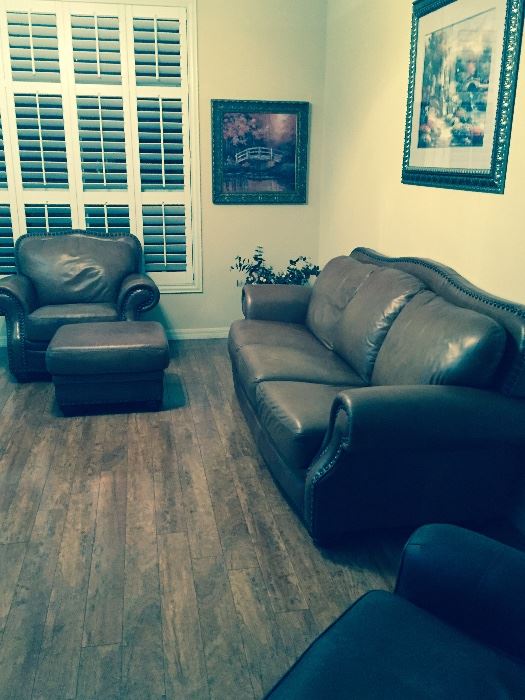 Genuine leather nailhead couch and chair with ottoman.
