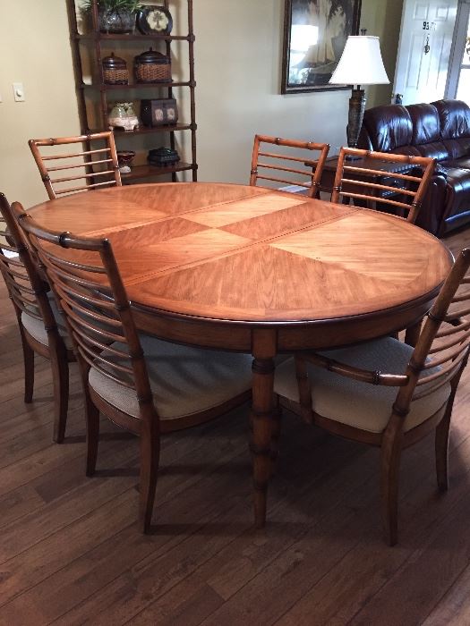 Tommy Bahama Style table, leaf and 6 chairs. Without leaf in, makes a round table. 