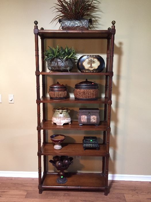 Solid wood 6 shelf stand with brass finials.