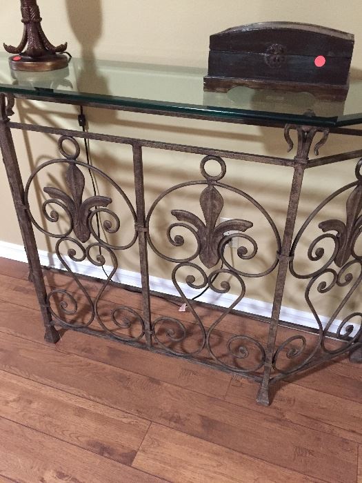 Beautiful wrought iron scroll base with heavy beveled glass top.
