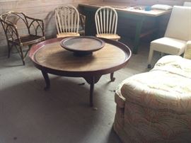 Queen Anne circular coffee table with edge; Pair of rattan chairs; pair of painted, oak seat kitchen chairs; four white upholstered dining chairs on casters.
