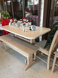 Small table with bench and three chairs