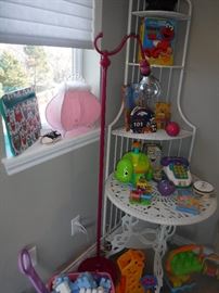 PINK LAMP, CORNER SHELVE UNIT, METAL ROUND TABLE AND PLENTY OF TOYS.