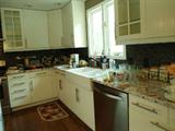 Kitchen is full...counter tops and the large Island in the center is full of kitchen items......Don't forget to look in the wet bar area between the dining room and the kitchen area....Clocks, Oak wooden coat rack, etc...
Also just located a beautiful wood/w/door wine cabinet which is located in the Dining Room...WOW! what a find.