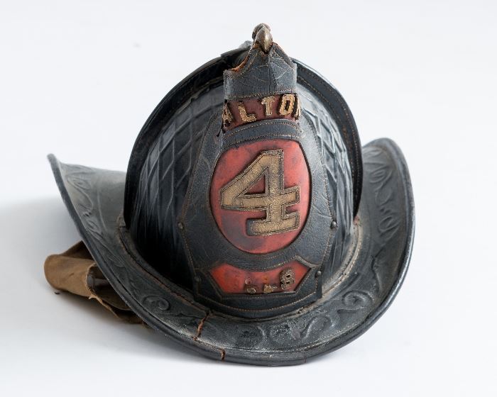 Historic Alton, Illinois Leather billed firemen's helmet from the 1880's. This fire helmet is one of a kind. There is a brass eagle on the top with it's bill over the front shield showing the city of Alton. The leather is in pretty good shape for as old as it is. There is one crack in the leather in the front of the hat. This helmet is a Caims 92 4 comb leather helmet with a cross comb pattern. It is a parade weight helmet circa 1880s.