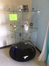    rotating glass curio shelving unit $120