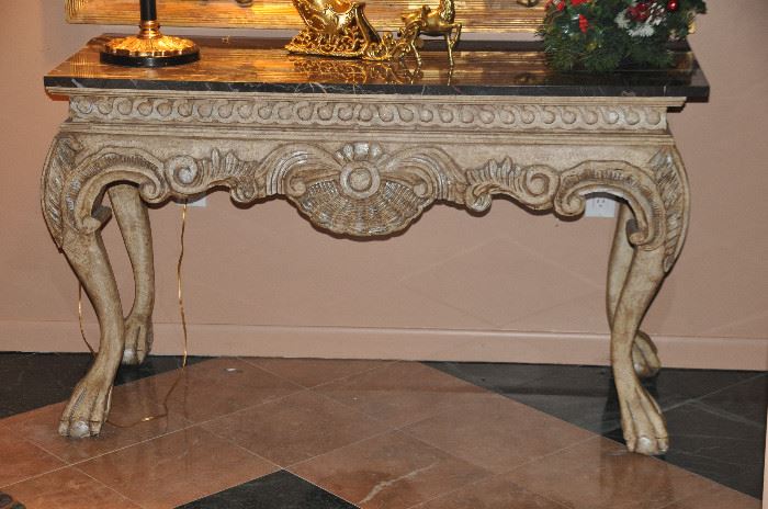 Foyer table has great detail and a marble top