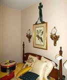 Four poster bed with mattresses! Many, many fabulous decorator pillows, framed magnolia print and decorative plates on sconce shelves.