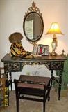 A hand painted black and gold dressing table with mirror and vanity bench. One of the owner's favorite things. Items on the dressing table include a mink hat in excellent condition and a Chanel scarf - one of many beautiful scarves in this estate.
