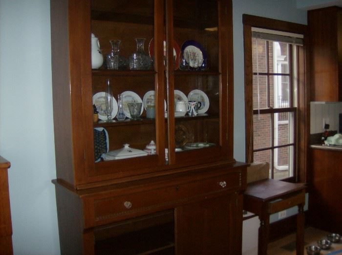 Very Antique  china cabinet . Glass doors opening to shelves, two drawers, cabinets below,. Lovely caraved detail around doors.   
