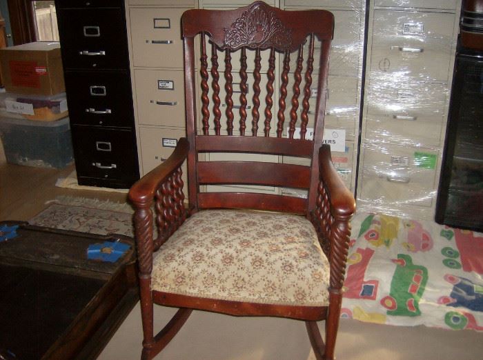 Antique rocking chair w/ barley twist detail and carved header               Also showing 5 four drawer metal file cabinets available 